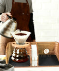 Person using Acacia Wood Coffee Bar Station Organizer Stand For Pour Over Nerds And Filter Holders Countertop Wooden Caddy