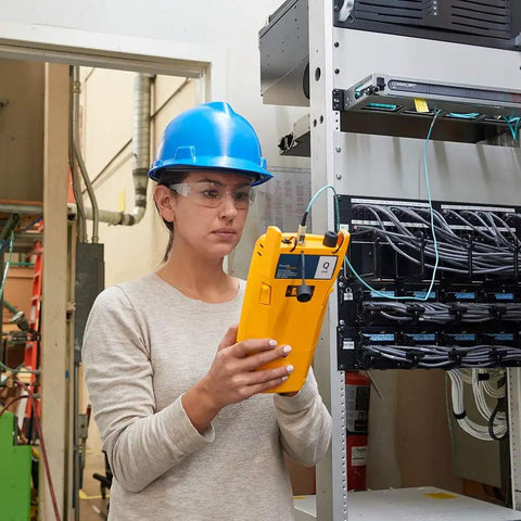 Woman using Slick Fiber Optics Testing Kit Hella Versatile With Quad OTDR And OLTS Modules for LAN Datacenter setup.