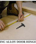 Measuring wood panel with tape next to Vintage Style Black Zinc Alloy Tee Door Hinges 2 Pack Slip Joint Lift Off