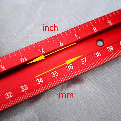Close-up of red scale in inches and millimeters on Adjustable Router Jig For Cutting Boards And Grooves, Square Template Guide With A 23.6 By 23.6 Inch Frame, Precise, Easy To Use Woodworking Jig For Perfect Grooves In Red.