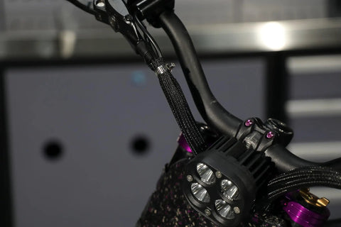 Close-up of 4 to 5 inch E Bike Cable Management Sleeve on handlebars showing split sleeve design for off-road electric motos and dirt bikes.