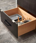 Open drawer with kitchenware, featuring a 12 Pack Matte Black Cabinet Handle Aluminum Drawer Pull for Sliding Doors