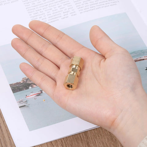 Brass 1/4-inch compression tube fittings, 2 pcs, held in hand