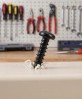 Grab These Happyyami M4x14mm Black Pan Head Self Tapping Screws With Cross Recess And Flat Point, standing on a workbench with shavings.
