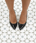 Top view of feet on Stellar Peel And Stick Floor Tiles Pack Of 10 White And Grey Geometric Vinyl Tiles Water Resistant 12x12 inches