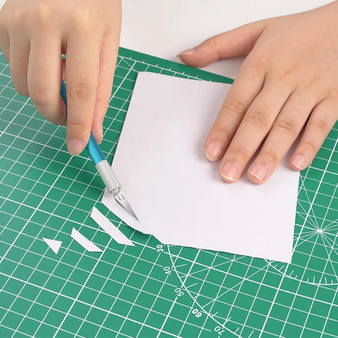 Hands using a craft knife on Cutting Mat 12 By 18 Inch Self Healing Double Sided for Sewing and Quilting Fabric Cutting Mat for Crafts