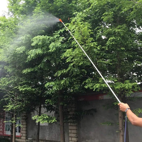 Person using Retractable Stainless Steel Sprayer Wand Extension Pipe Tool For Garden Farm And Horticulture Use, spraying trees