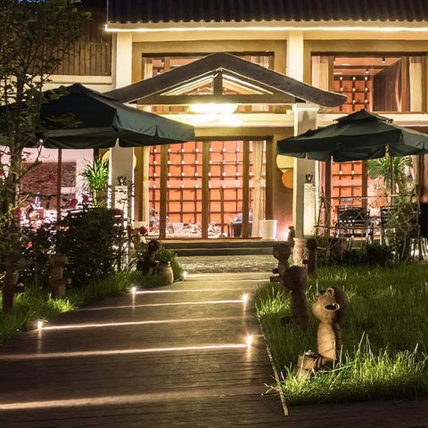 Night view with pathway lit by low voltage landscape light bulbs T5 11W 12V wedge base, creating a soft warm white glow for outdoor fixtures.