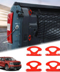 Rock Solid Carbon Steel Tie Down Hooks Four Pack For Ford Maverick 2022 To 2025 red anchors attached to a truck bed.