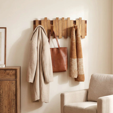 Premium Acacia Wood Wall Mounted Coat Rack With Eight Retractable Hooks holding a coat and bag in an entryway.