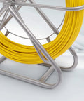 Close-up of yellow 425 Ft Fiberglass Fish Tape, steel wheel stand, visible quarter-inch fishtape coil for wire pulling.