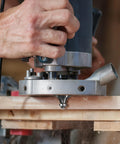Carpenter using router with 15 Piece Router Bit Set One Quarter Inch Shank Tungsten Carbide Woodworking Bits for precise cuts.