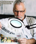 Man reading newspaper using LED Magnifying Desk Lamp With Clamp, Dimmable 3 Lighting Modes, 10W Task Light, 225 Percent Magnification