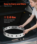Person placing a 27 Inch Smokeless Fire Pit Stand For Solo Stove Bonfire Pro Grade Stainless Steel Ring Frame in car trunk