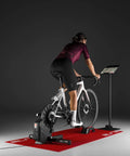 Cyclist on bike using Rivo Direct Drive Smart Trainer For Indoor Cycling With Accurate Power Within 2.5 Percent, Auto Resistance, 18 Percent