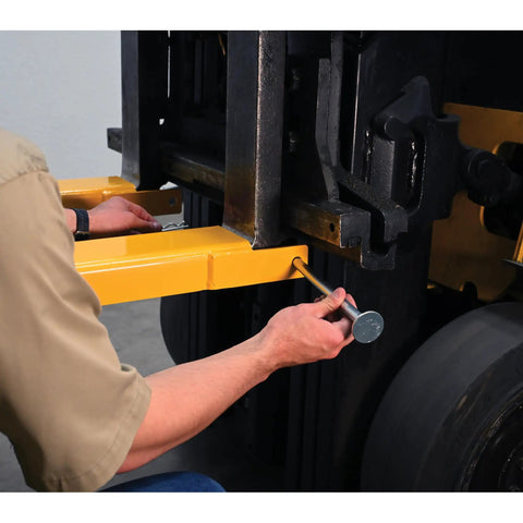 Installing Heavy Duty Pin Lock Forklift Extensions Boss Level Steel Bars 4000 Lb Capacity on a forklift for easy mounting.