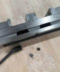 Six Inch Double Lock Cnc Machine Vise With Hardened Steel Bed and Reversible Step Jaws, showing top view with handle.