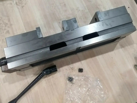 Six Inch Double Lock Cnc Machine Vise With Hardened Steel Bed and Reversible Step Jaws, showing top view with handle.