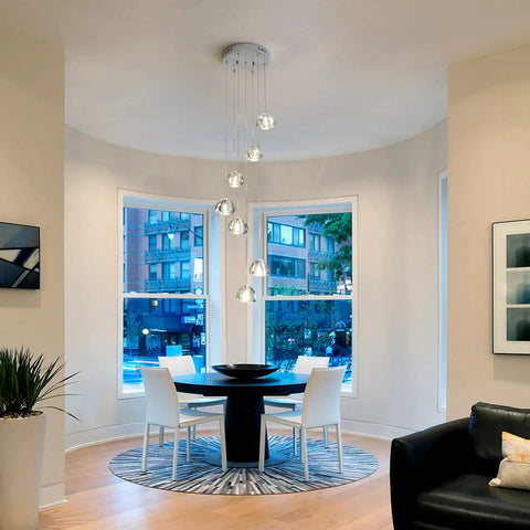 Modern LED Crystal Chandelier Pendant Lighting With Seven Lights in chrome finish above dining table in bright room
