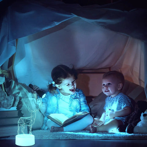 Kids reading under a blanket with a 35 Pack 3D LED Light Bases With Remote Control 16 Colors USB Powered Acrylic Night Lamps Stand nearby.
