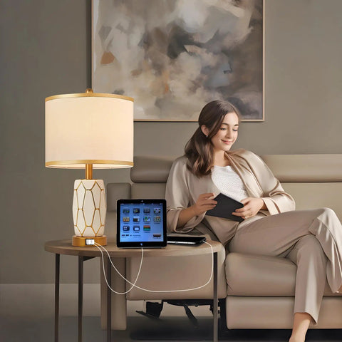Set Of 2 Touch Control Ceramic Table Lamps For Bedroom And Living Room Modern Black And White Design With USB Ports Bedside Nightstand Lamps With Fabric Drum Shade Bulbs Included, showing one lamp on a side table beside a woman on a sofa.