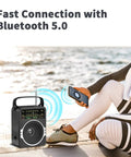 Woman using Portable AM FM Radio With Bluetooth Five Point Zero And Five Watt Loud Speaker by the beach
