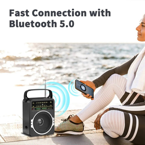 Woman using Portable AM FM Radio With Bluetooth Five Point Zero And Five Watt Loud Speaker by the beach