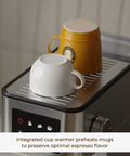 Top Shelf No Fuss 20 Bar Espresso Machine With Built In Grinder And Fast Milk Frother Stainless Steel All In One Coffee Maker Featuring Easy Lcd Display pouring espresso into preheated mugs.