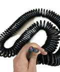 Heavy Duty Retractable Twin Spiral Extension Cord With Four 2.5 Mm Conductors Stretching Up To Ten Meters held in hand.