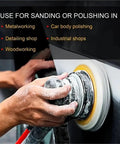 Hand using a power tool with Premium 5 Inch Hook And Loop Sanding Discs With Durable Aluminum Oxide abrasive for polishing metal.