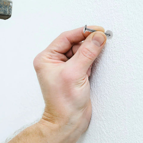 Inserting Heavy Duty Self Drilling Drywall Anchors And Screws Kit into gypsum board for easy install and strong hold