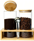 Two 49oz Airtight Glass Coffee Canisters With Bamboo Shelf, Stainless Spoon And Anti Slip Pads For Storage Jars For Coffee Beans, Ground Coffee, And Nuts, Perfect Coffee Bar Organizer with visible coffee beans and ground coffee.