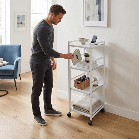 Man organizing the White 4 Tier Rolling Kitchen Cart With Pull Out Shelf Adjustable Middle Racks And Secure Locking Wheels.