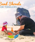 Man and toddler playing with Kids Sand Shovel Bulk Pack 12 Heavy Duty Plastic Beach Shovels For Beach Day Chaos Garden Tool Sandbox Toys.