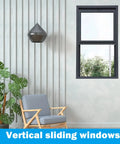 Vertical sliding window in modern room with chair and plant, suitable for Adjustable Window Security Bar For Home Safety And Kid Protection