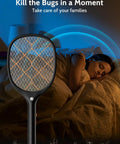 Electric Fly Swatter Zapper Racket 4000V Beast Mosquito Killer With LED Light shown indoors with sleeping person in background