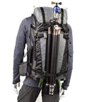BackLight Elite 45L Camera Daypack, Rugged Grey, model wearing backpack with tripod attached, travel ready for pro gear