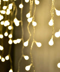 Fairy Curtain Lights USB Powered And Battery Operated 13ft 96 LED Globe Icicle String For Bedroom Dorm Wedding Party Christmas Decor Cozy Warm White Ambience, close-up view of warm white LEDs