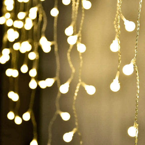 Fairy Curtain Lights USB Powered And Battery Operated 13ft 96 LED Globe Icicle String For Bedroom Dorm Wedding Party Christmas Decor Cozy Warm White Ambience, close-up view of warm white LEDs