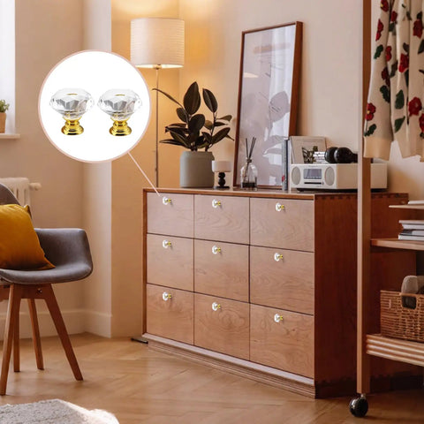 12 Pack 30mm Gold Crystal Cabinet Knobs Featuring Slick Diamond Cut Glass Faces And Durable Aluminum Alloy Backplates on a dresser.