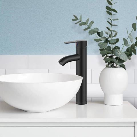Vessel Sink Faucet Sleek Matte Black One Hole Deck Mount Lavatory Mixer Tap with Water Supply Hoses and ABS Pop Up Drain No Overflow Single Handle Vanity Faucet for Stylish Bathroom next to a white vessel sink on a white tiled countertop.