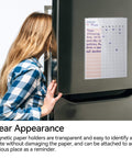 Person using 15 Pack Magnetic Sign Holders For 8.5 By 11 Documents, Rigid Clear Plastic Frames With Strong Magnetic Borders on a fridge.