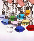 Colorful keychains resembling gems, not part of the 50 Pack Mini LED Lights Kit For Crafts And Dollhouses RGB Color Changing Battery Powered