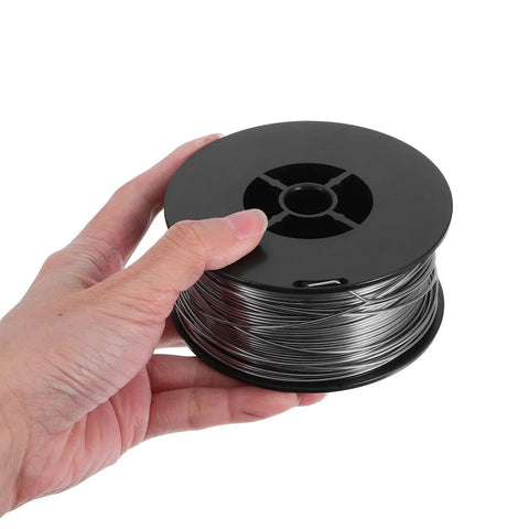 1KG Flux Core Welding Spool With Self-Shielding Metal Tin Wire for Precision Electronics Projects held in hand.