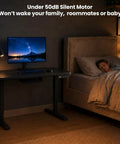AdGiGi 40 Inch Electric Standing Desk Adjustable Height Sit Stand Workstation Compact Computer Table For Home Office Small Space Black, shown in a bedroom with a child sleeping.