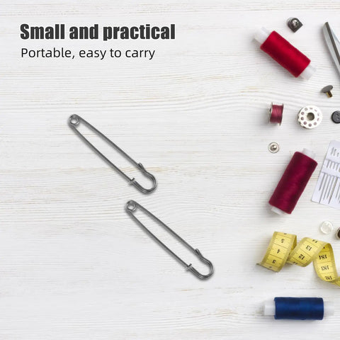 Premium Heavy Duty Safety Pins And Weatherproof Retro Brooches Perfect For Jackets Hats And Industrial Projects With Precision Opening Mechanism To Keep Everything Secure Anywhere, two steel safety pins on a crafting table.