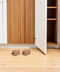Two gourd shaped wooden legs in front of cabinet, part of Four Pack Rubber Wood Furniture Leg Replacements For Sofas And Cabinets