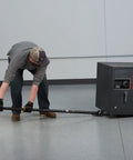 Man using Heavy Duty Pry Bar Lever With 6600 Lb Capacity, 55 Inch Handle, Special Nose Plate And Four Steel Rollers to move equipment