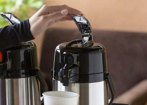 ECAL22S Eco Air Lever Airpot With Glass Vacuum Insulated Beverage Dispenser 2.2 Liter thermal carafe in use, lever pressed