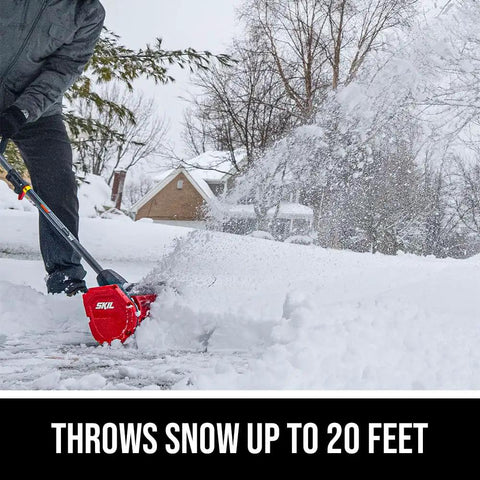 Badass Brushless 40 Volt Cordless Snow Shovel Kit with a 12 inch deck clearing snow on a driveway, throwing snow up to 20 feet.